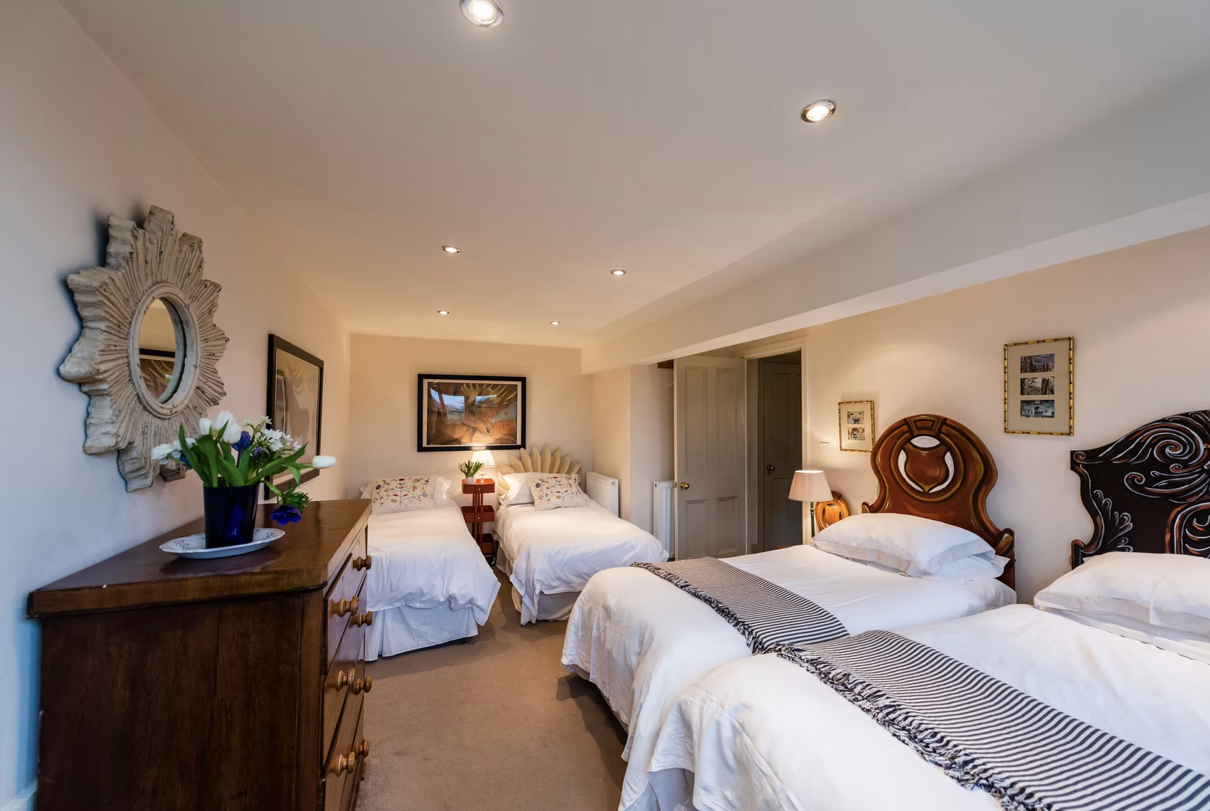 Bedroom with four single beds and antique wooden furniture