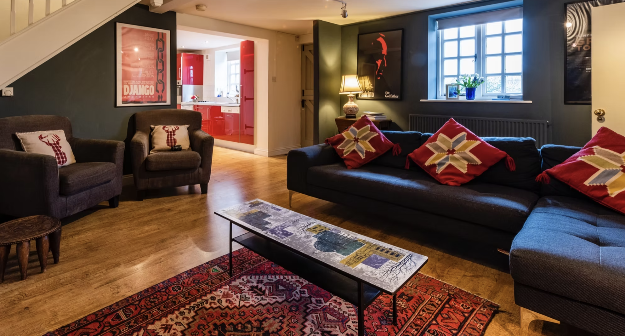 Cosy movie snug with dark blue sofas and framed film posters