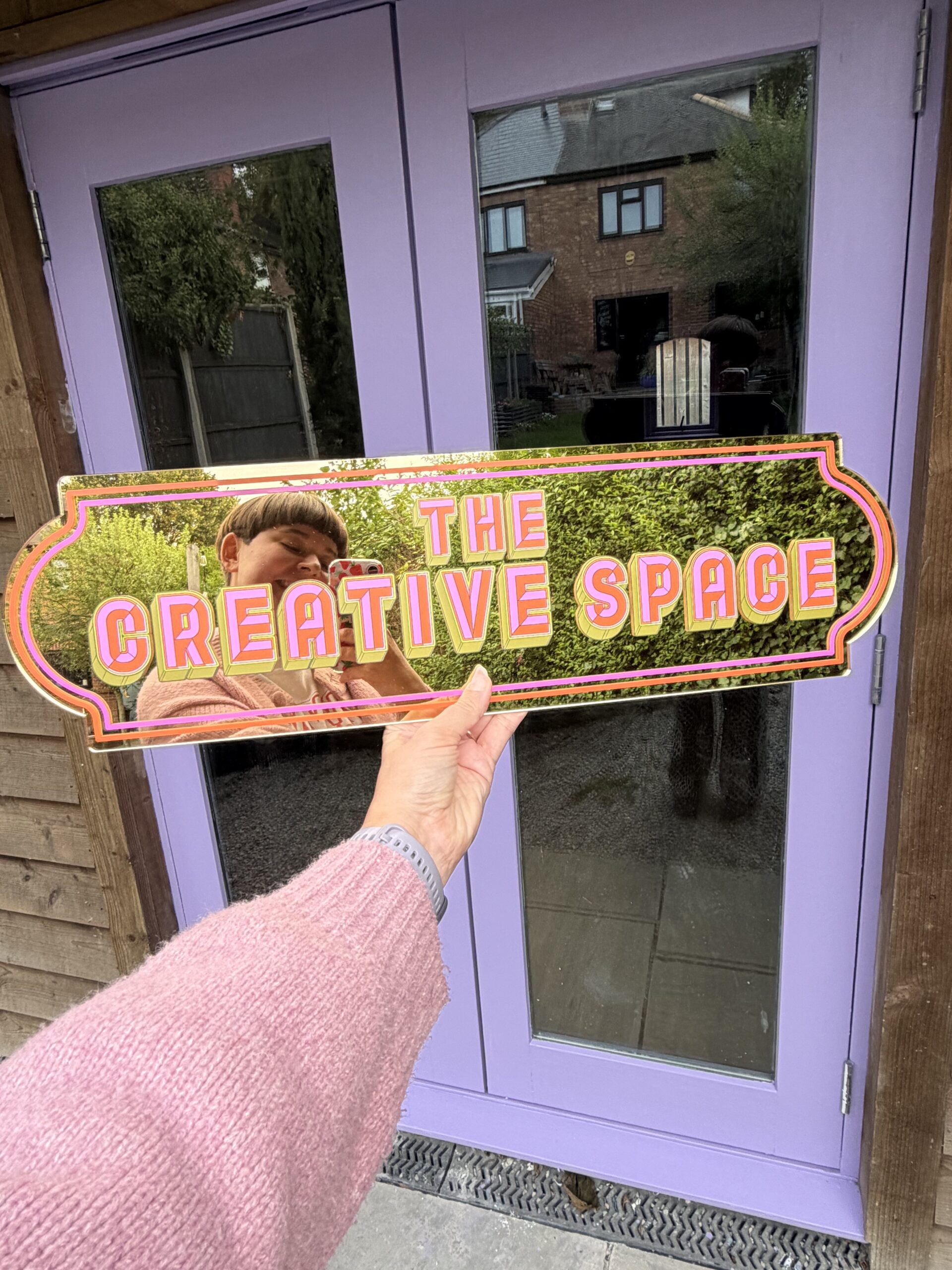 Bright garden-room craft studio with plants and materials laid out